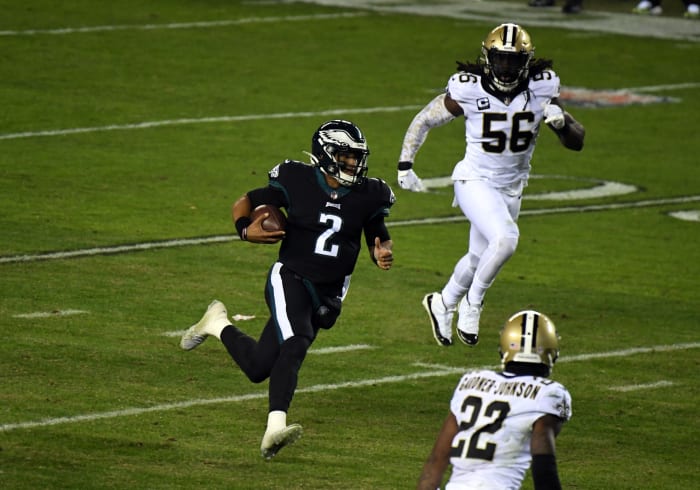 Eagles quarterback Jalen Hurts (2) rushes the ball as New Orleans Saints linebacker Demario Davis (56) and safety Chauncey Gardner-Johnson (22) pursue. Mandatory Credit: James Lang-USA TODAY Sports